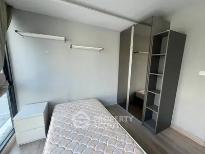 Minimalist bedroom with mattress and built-in wardrobe, perfect for urban living.