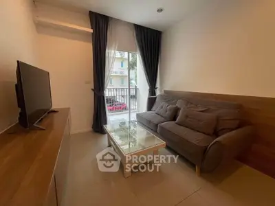 Cozy living room with modern sofa and TV, perfect for relaxation.