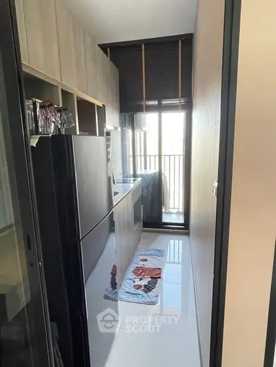 Modern compact kitchen with sleek appliances and balcony view