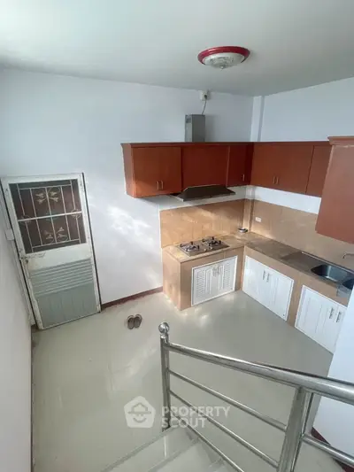 Modern kitchen with gas stove and sleek cabinetry in a compact layout
