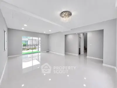 Spacious modern living room with elegant chandelier and glossy tile flooring