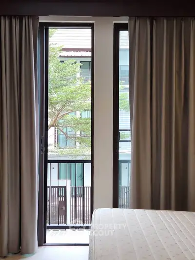 Modern bedroom with large window and balcony view