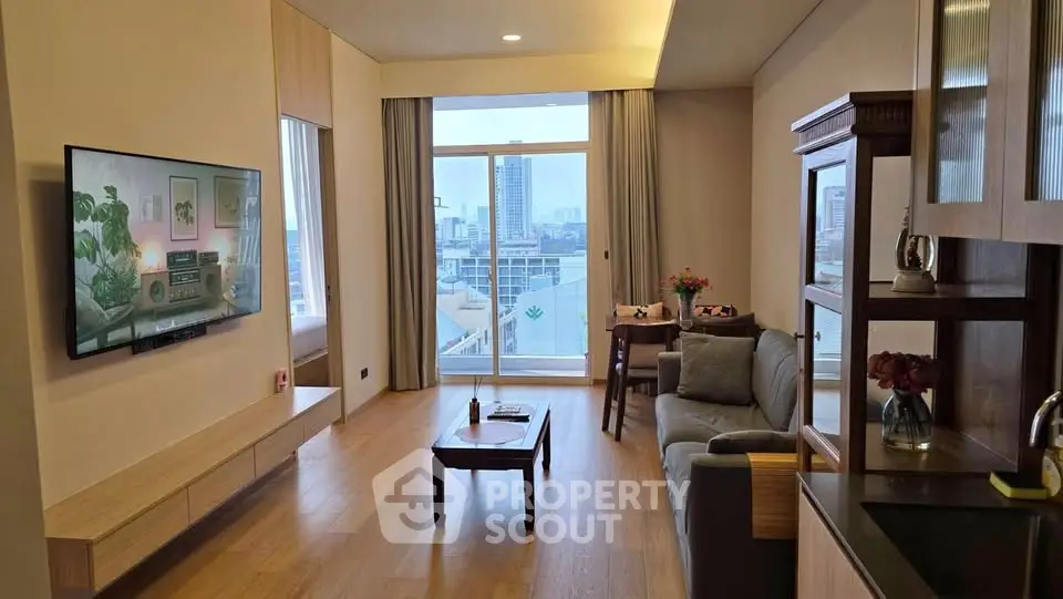 Modern living room with city view, featuring sleek furniture and a wall-mounted TV, perfect for urban living.