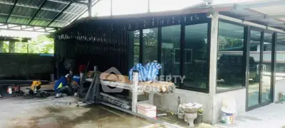 Modern industrial-style building with large glass windows and metal roofing, showcasing a versatile workspace.