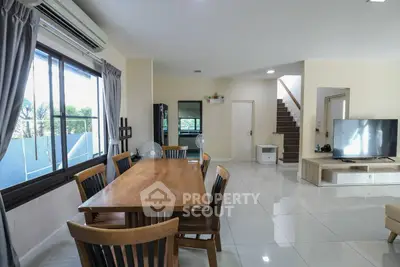 Spacious modern living room with dining area and large windows