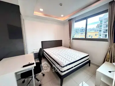 Modern bedroom with large window and sleek furniture in urban apartment