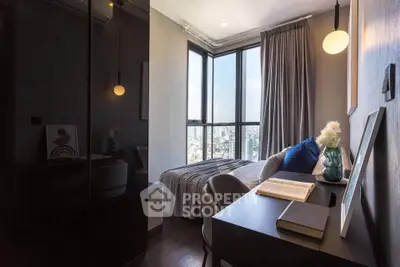 Cozy bedroom with city view, modern decor, and study desk in a high-rise apartment.