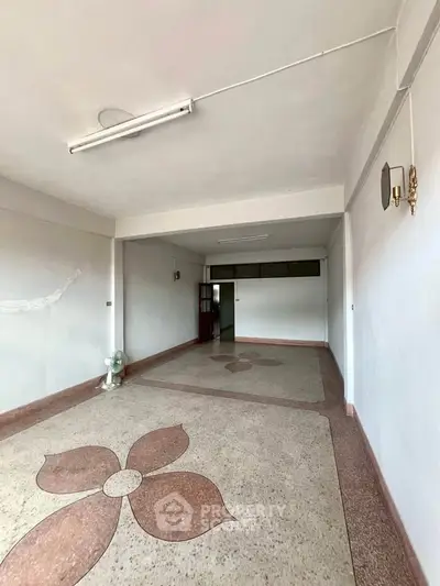 Spacious interior with unique floor design and ample natural light, perfect for creative transformations.