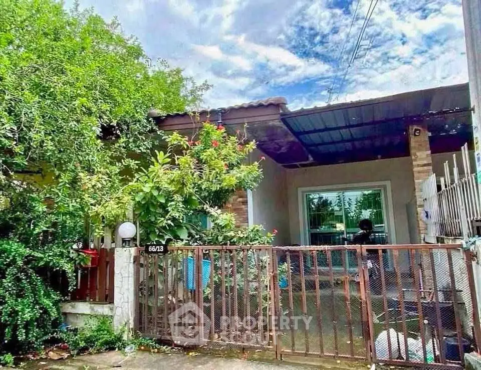 Charming single-story home with lush garden and gated entrance, perfect for serene living.