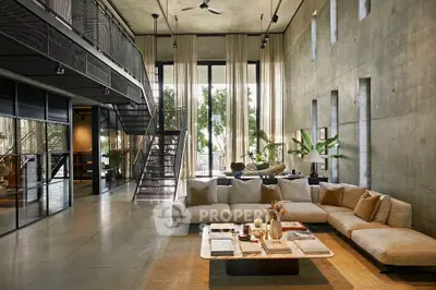 Luxurious modern living room with high ceilings and large windows offering natural light.