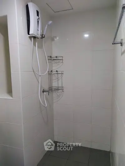 Modern bathroom with sleek shower and tiled walls, perfect for a minimalist home design.