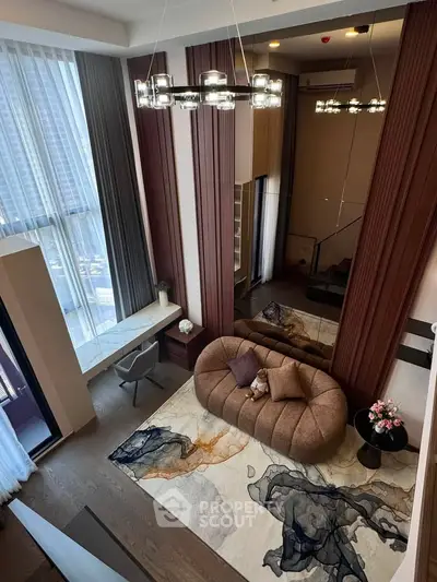 Luxurious modern living room with high ceilings, elegant chandelier, and stylish furniture in a high-rise apartment.