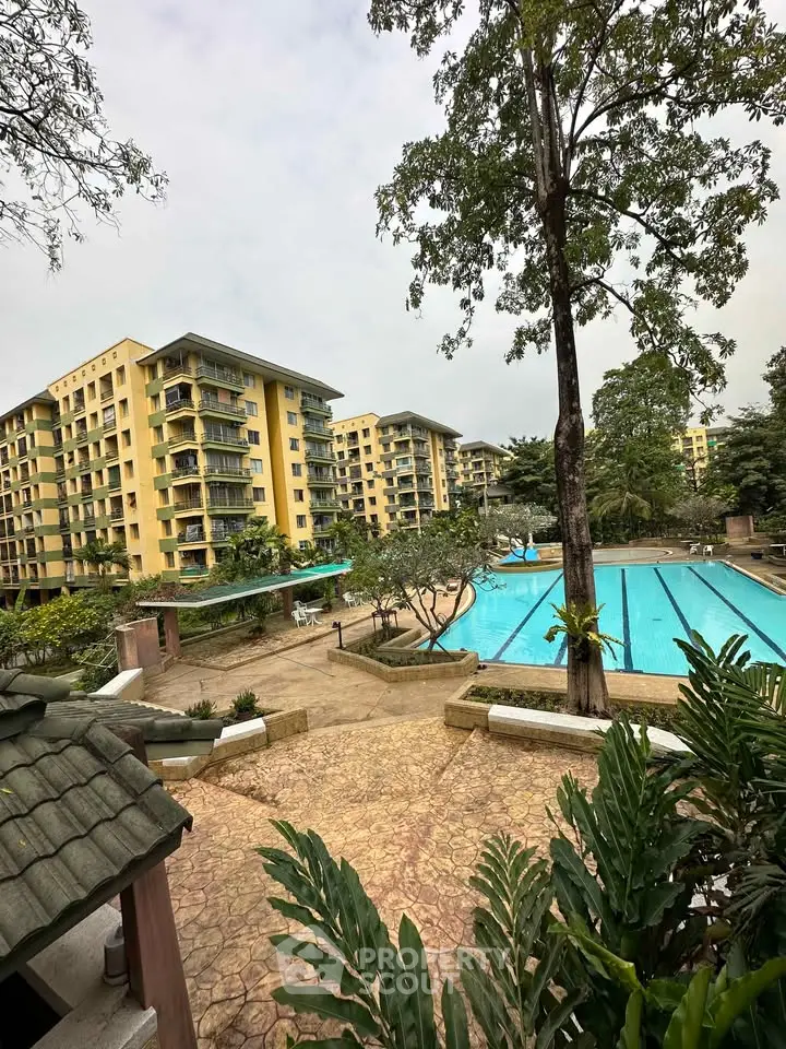 Luxurious residential complex with pool and lush greenery, perfect for modern living.