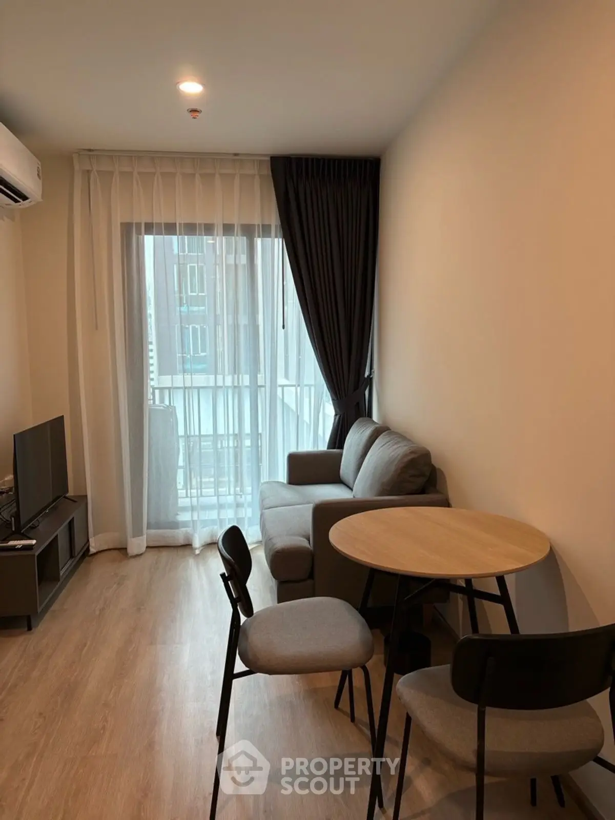 Cozy modern living room with natural light and stylish furniture, perfect for relaxation and entertainment.