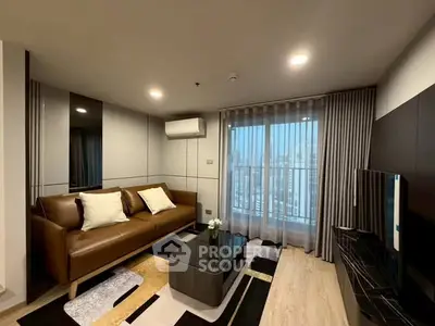 Modern living room with city view, featuring sleek furniture and stylish decor.