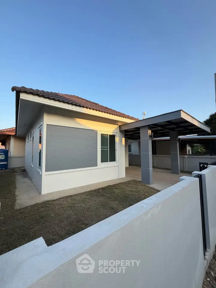 Charming single-story home with modern design and spacious carport, perfect for family living.
