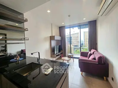 Modern living room with open kitchen and balcony view