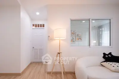 Modern living room with cozy white sofa and stylish floor lamp