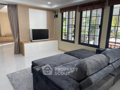 Spacious living room with modern decor and large windows for natural light.