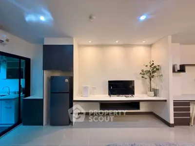 Modern living room with sleek design and integrated kitchen view