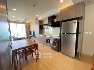 Modern open-layout kitchen with dining area and balcony view