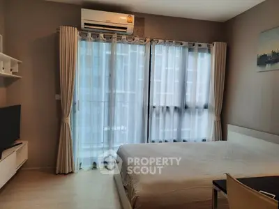 Modern bedroom with large window and air conditioning in urban apartment