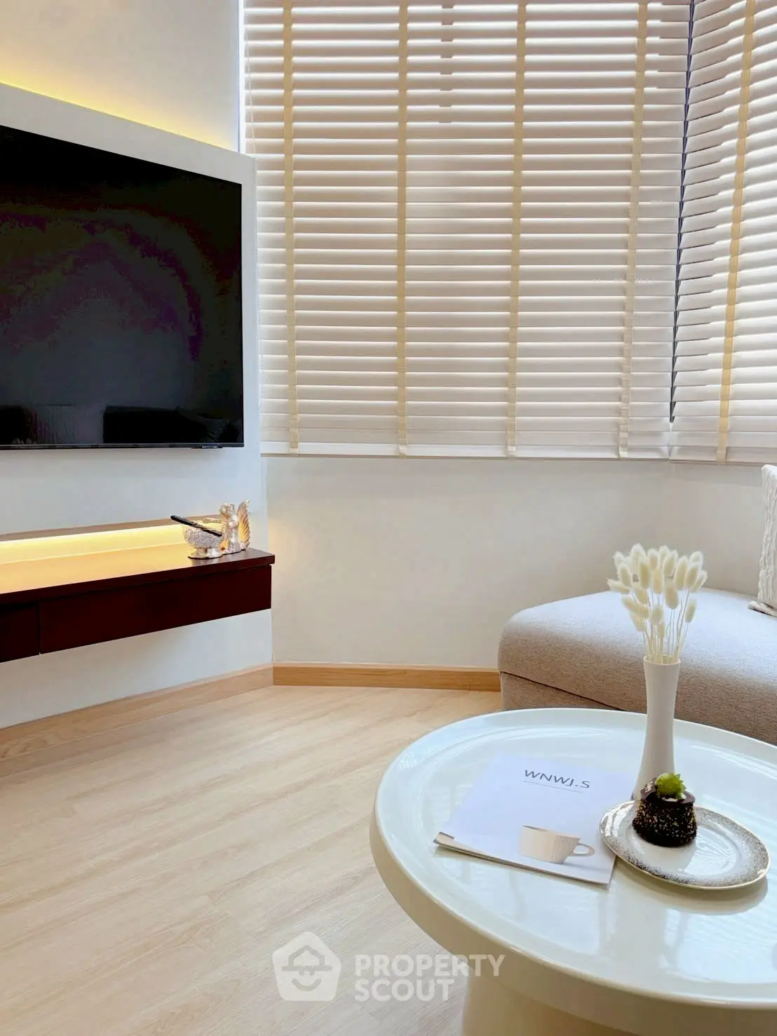 Modern living room with sleek TV setup and cozy seating area