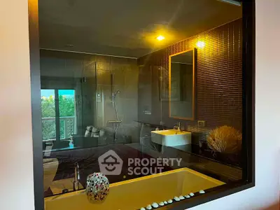 Luxurious bathroom with modern fixtures and a spacious bathtub offering a serene view.