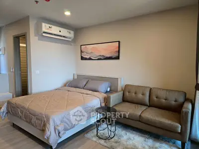 Modern bedroom with cozy sofa and stylish decor