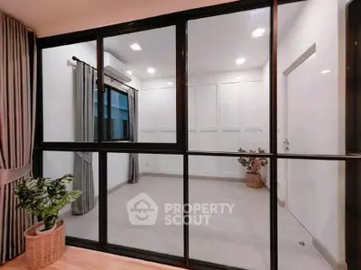 Modern interior with glass partition and elegant decor in a stylish apartment.