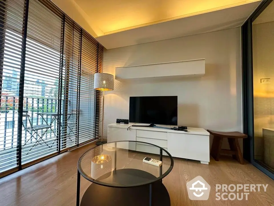 Modern living room with stylish decor and large windows offering a stunning city view.