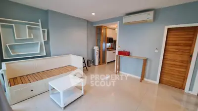Spacious living room with modern decor and air conditioning in a stylish apartment.