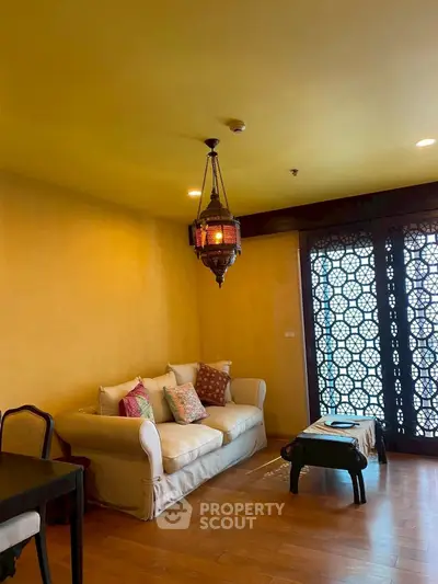 Charming living room with exotic decor and cozy seating in a stylish apartment.