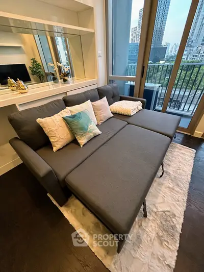 Stylish living room with modern sofa and city view balcony, perfect for urban living.