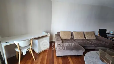 Spacious living room with cozy sectional sofa and modern wooden flooring