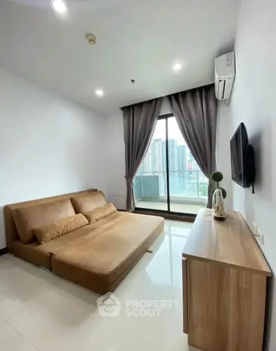 Modern living room with city view, featuring sleek furniture and large windows for natural light.