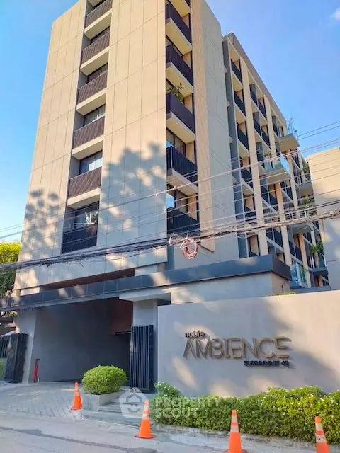 Modern residential building with stylish facade and lush greenery