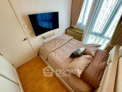 Cozy modern bedroom with wall-mounted TV and large window view
