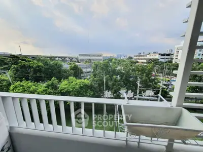 Stunning balcony view with lush greenery and cityscape in the background