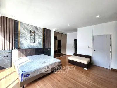 Spacious modern bedroom with stylish decor and natural light