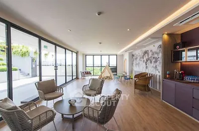 Spacious modern living room with large windows and outdoor access, perfect for relaxation and entertainment.