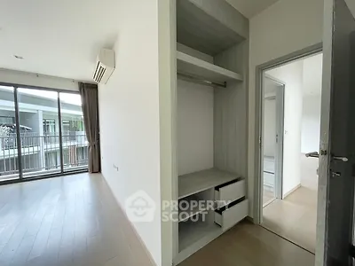Spacious bedroom with built-in wardrobe and access to a private balcony, featuring ample natural light and modern flooring, ideal for personal customization.