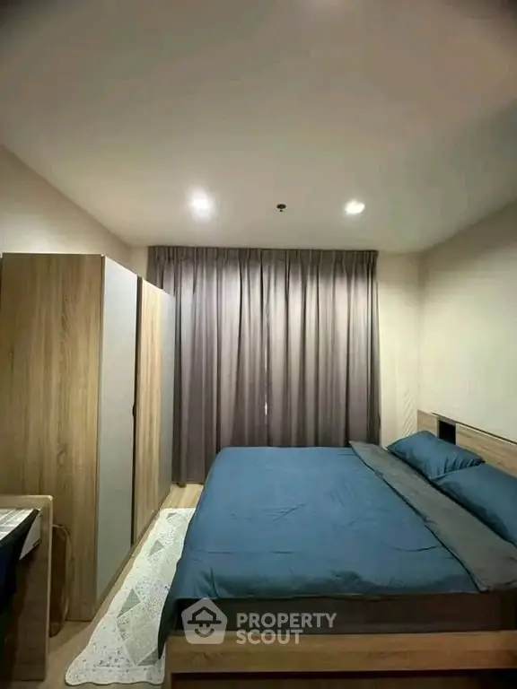 Cozy bedroom with modern furnishings and ample natural light, perfect for relaxation and comfort.