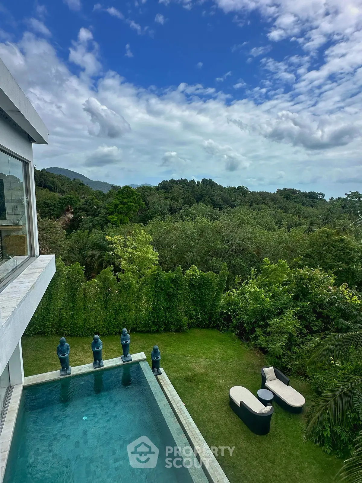 Luxurious villa with stunning pool and lush garden view