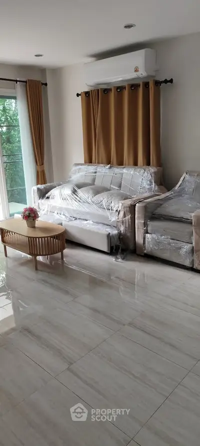 Spacious living room with modern furniture and large windows for natural light.