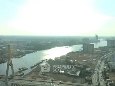 Stunning high-rise view of cityscape and river with iconic bridge, perfect for urban living enthusiasts.