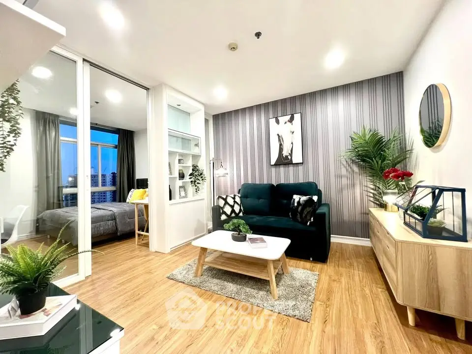 Modern living room with stylish decor and view into cozy bedroom