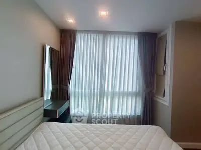Modern bedroom with large window and elegant curtains, featuring a comfortable bed and stylish decor.