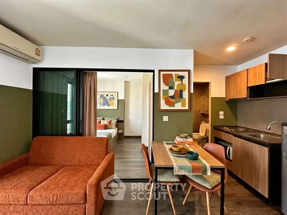 Modern open-plan living room and kitchen with stylish decor and cozy ambiance.