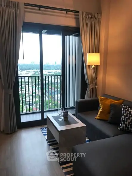 Stylish living room with balcony view in modern apartment